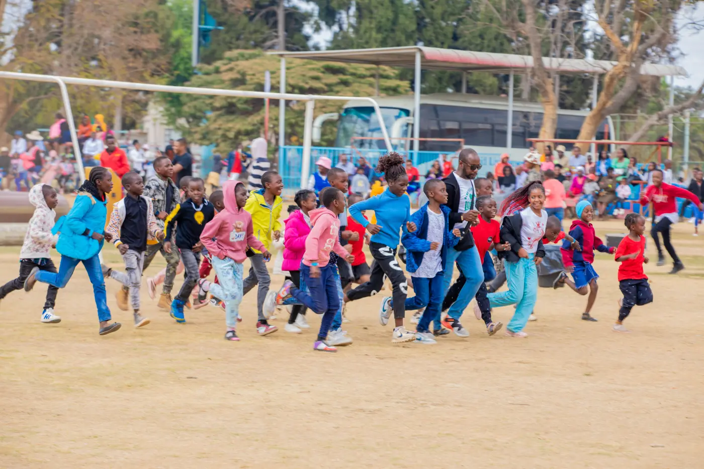 Children running together during a VNZ community activity