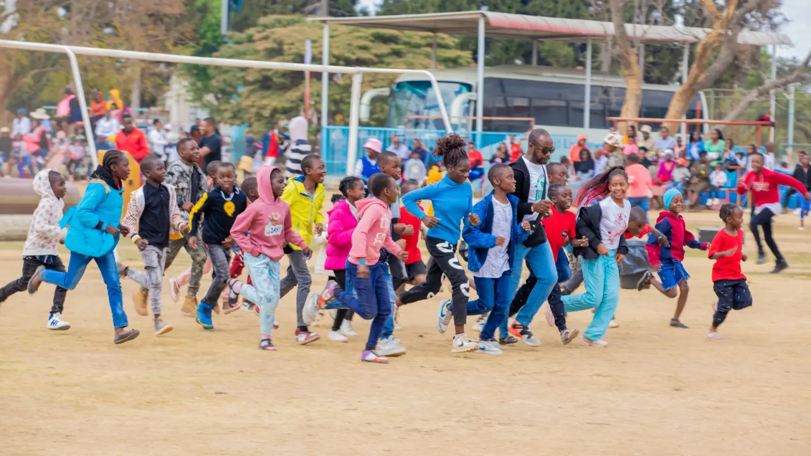 Children and volunteers celebrating during a supervised community activity
